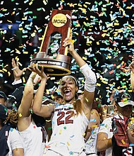 University of South Carolina forward A’ja Wilson holds the NCAA championship trophy aloft after the team’s 67-55 victory in Dallas.