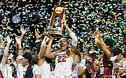 University of South Carolina forward A’ja Wilson holds the NCAA championship trophy aloft after the team’s 67-55 victory in Dallas.