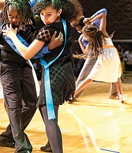 Shall we dance?
Julius Jackson, left, and Tristan Albers perform the tango Monday at the Dancing Classrooms GRVA Colors of the Rainbow Team Match. The youngsters from Richmond’s Chimborazo Elementary School learned more than ballroom dance moves in the 10-week program. Please see more photos on A5.