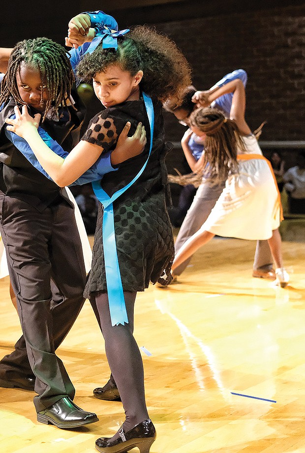 Shall we dance?
Julius Jackson, left, and Tristan Albers perform the tango Monday at the Dancing Classrooms GRVA Colors of the Rainbow Team Match. The youngsters from Richmond’s Chimborazo Elementary School learned more than ballroom dance moves in the 10-week program. Please see more photos on A5.