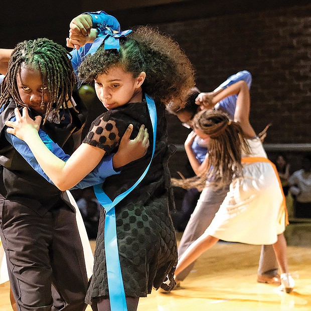 Shall we dance?
Julius Jackson, left, and Tristan Albers perform the tango Monday at the Dancing Classrooms GRVA Colors of the Rainbow Team Match. The youngsters from Richmond’s Chimborazo Elementary School learned more than ballroom dance moves in the 10-week program. Please see more photos on A5.