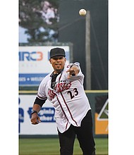 Three-time All-Star outfielder David Justice throws out the ceremonial first pitch at the Richmond Flying Squirrels opening day April 6 at The Diamond. Because his flight was delayed, his pitch came during the game’s third inning.