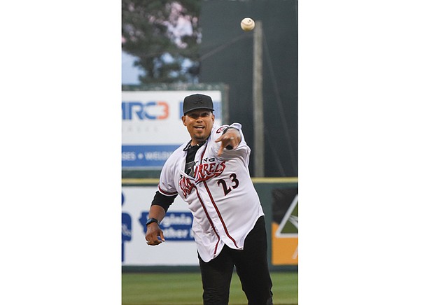 Three-time All-Star outfielder David Justice throws out the ceremonial first pitch at the Richmond Flying Squirrels opening day April 6 at The Diamond. Because his flight was delayed, his pitch came during the game’s third inning.