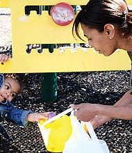 Found one! //
When it comes to hunting Easter eggs, Drew-Els Layne is leaving no spot unexplored. The 2-year-old hands her mother, LaTwanya Dukes, an egg she found under playground equipment last Saturday at the Easter Egg Hunt and Celebration at Blackwell Community Center. Please see more photos, B2.