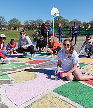 Cityscape // A team of volunteers paints a map of U.S. states on the Woodville Elementary School playground Saturday. From left, they are Katrina Washington, Michael Hill, Katie Gallagher, Tara Wagstaff, Olivia Jenkins, Laura D’Antonio and Victoria Hauser. Right, Richmond Schools Superintendent Dana T. Bedden  joins Michael Hill, a fourth-grader at William Fox Elementary School, in painting Florida. 
This is one of six school playgrounds gaining such maps. The project is the work of the Junior League of Richmond. 