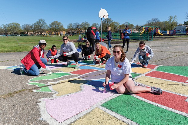 Cityscape // A team of volunteers paints a map of U.S. states on the Woodville Elementary School playground Saturday. From left, they are Katrina Washington, Michael Hill, Katie Gallagher, Tara Wagstaff, Olivia Jenkins, Laura D’Antonio and Victoria Hauser. Right, Richmond Schools Superintendent Dana T. Bedden  joins Michael Hill, a fourth-grader at William Fox Elementary School, in painting Florida. 
This is one of six school playgrounds gaining such maps. The project is the work of the Junior League of Richmond. 