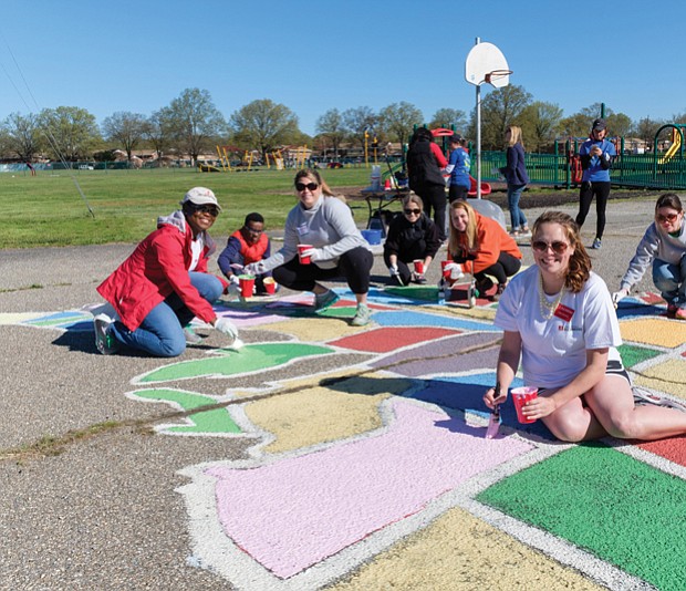Cityscape // A team of volunteers paints a map of U.S. states on the Woodville Elementary School playground Saturday. From left, they are Katrina Washington, Michael Hill, Katie Gallagher, Tara Wagstaff, Olivia Jenkins, Laura D’Antonio and Victoria Hauser. Right, Richmond Schools Superintendent Dana T. Bedden  joins Michael Hill, a fourth-grader at William Fox Elementary School, in painting Florida. 
This is one of six school playgrounds gaining such maps. The project is the work of the Junior League of Richmond. 