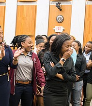 Honoring hometown champions  //
Virginia Union University basketball standout Ashley Smith, center, reacts to laudatory comments made by Richmond City Council President Chris A. Hilbert during Monday night’s City Council meeting. Ms. Smith, her teammates with the Lady Panthers and Coach AnnMarie Gilbert, left, were recognized by Mayor Levar M. Stoney and City Council for their championship showing in this year’s NCAA Division II Tournament. The Elite Eight team lost in the tournament final to Ashland University of Ohio. During the tournament, Dominion Energy lighted up its Downtown building with a message of support for the Lady Panthers. Mr. Hilbert said Monday the team lighted up the hearts of all Richmonders with its championship skill, poise and spirit. Ms. Smith scored 28 points in the team’s semifinal victory over California Baptist University, a feat Mr. Hilbert said he could never achieve, evoking laughter from the team.   