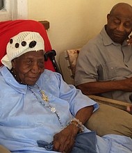 Violet-Mosse Brown, known as Aunt V, celebrates her 117th birthday with her son, 97.