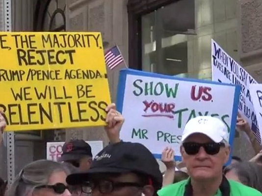 Hundreds of people protested during the Tax March in downtown Houston on Saturday in hopes of pressuring President Trump to …