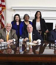 Maryland Governor Larry Hogan signs SB 217 surrounded by state and local law enforcement officials. SB 217 changes the state's legal definition of rape, bringing it in line with most other states.