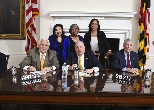 Maryland Governor Larry Hogan signs SB 217 surrounded by state and local law enforcement officials. SB 217 changes the state's legal definition of rape, bringing it in line with most other states.