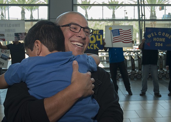 Chief Gunner's Mate Adan Macias, assigned to Littoral Combat Ship (LCS) Crew 204, embraces his son during a homecoming celebration …