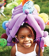 In her Easter bonnet //
Laniyah Massenburg shows off her custom-made balloon bonnet crafted at the annual Easter on Parade celebration last Sunday on Monument Avenue. The 3-year-old was right at home with the bright flowers and painted eggs adorning her bonnet. Please see more photos, B3.