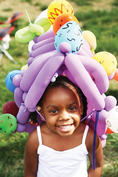 In her Easter bonnet //
Laniyah Massenburg shows off her custom-made balloon bonnet crafted at the annual Easter on Parade celebration last Sunday on Monument Avenue. The 3-year-old was right at home with the bright flowers and painted eggs adorning her bonnet. Please see more photos, B3.