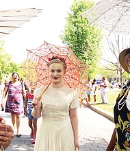 See and be seen  at Easter on Parade // three members of the Art Deco Society of Virginia, from left, Rita Shiang of Richmond, Anna Quilie of Carson and Christina Stewart-York of Chesterfield, draw admiring stares and some mutual admiration for their decorative parasols. 
