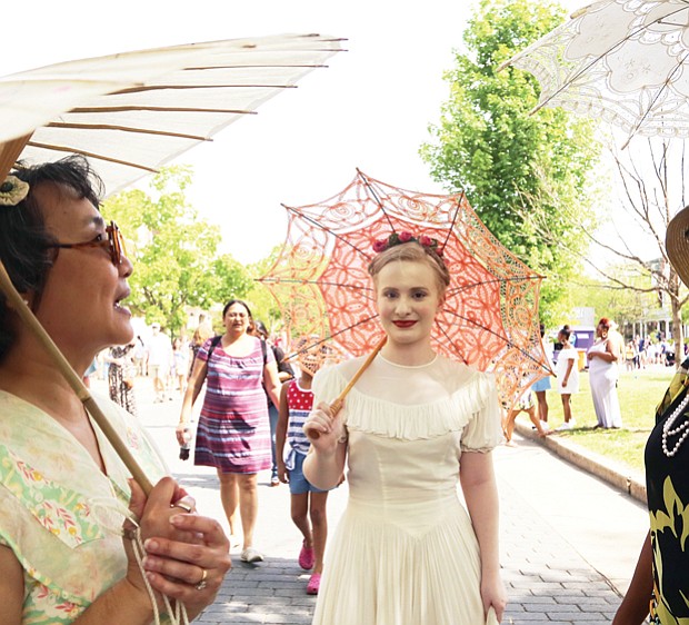 See and be seen  at Easter on Parade // three members of the Art Deco Society of Virginia, from left, Rita Shiang of Richmond, Anna Quilie of Carson and Christina Stewart-York of Chesterfield, draw admiring stares and some mutual admiration for their decorative parasols. 
