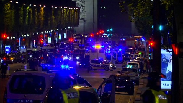 At least 20 police vehicles line the streets of the scene of a shooting in the Champs-Elysees area in Paris.