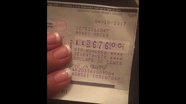 	Sergio Juarez returns money order to Yesenia Del Valle.
