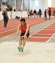 St. Christopher’s sophomore Frank Royal III lands during the long jump competition at a recent meet on the school’s indoor track.