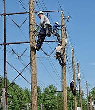 Men at work // Trainees in Dominion Energy’s lineman program work on power lines at the company’s Safety and Training Center in Chester. The photo opportunity on April 20 was part of the National Lineman Appreciation Day observance to raise public awareness about what it takes to keep the lights on for customers, no matter the weather. The lineman training process is seven steps over five years that combine classroom and field work. At the center, trainees learn to climb, make repairs from bucket trucks and troubleshoot equipment.