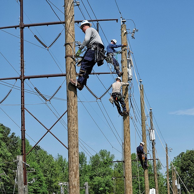 Men at work // Trainees in Dominion Energy’s lineman program work on power lines at the company’s Safety and Training Center in Chester. The photo opportunity on April 20 was part of the National Lineman Appreciation Day observance to raise public awareness about what it takes to keep the lights on for customers, no matter the weather. The lineman training process is seven steps over five years that combine classroom and field work. At the center, trainees learn to climb, make repairs from bucket trucks and troubleshoot equipment.