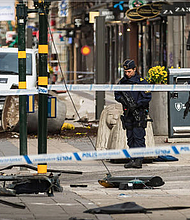 Police attend the scene of the terrorist attack where a truck crashed after driving down a pedestrian street in downtown Stockholm on April 8, 2017 in Stockholm, Sweden. 