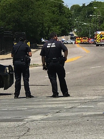 A gunman opened fire on an emergency medical technician vehicle, critically injuring a paramedic with the Dallas Fire-Rescue Department on Monday, according to a statement from the city's police department.