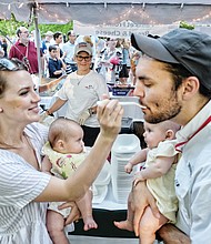 Julia and Jeff Schurott enjoy gumbo as their twin daughters, Eloise and Piper, can only watch. The annual event is a fundraiser supporting the work of the nuns in caring for the low-income elderly. 