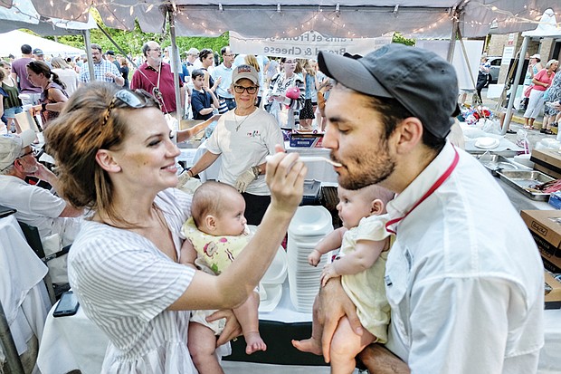 Julia and Jeff Schurott enjoy gumbo as their twin daughters, Eloise and Piper, can only watch. The annual event is a fundraiser supporting the work of the nuns in caring for the low-income elderly. 