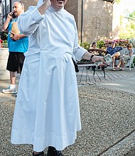 Ooh la la //  Sister Rose Marie, dressed in her habit and high-top hiking boots, talks on the phone after accepting a donation at the French Food Festival last Saturday at the Little Sisters of the Poor on Michaels Road in Henrico County.
