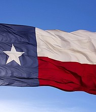 The flag of the State of Texas flies atop a flag pole