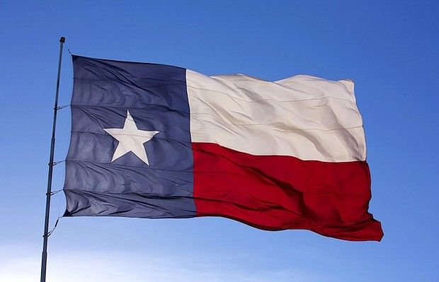 The flag of the State of Texas flies atop a flag pole