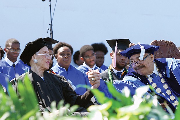 Retired NASA mathematician and pioneer Katherine G. Johnson, 98, gets a laudatory handshake from Hampton University President William R. Harvey after her videotaped commencement address Sunday to graduates and their families.