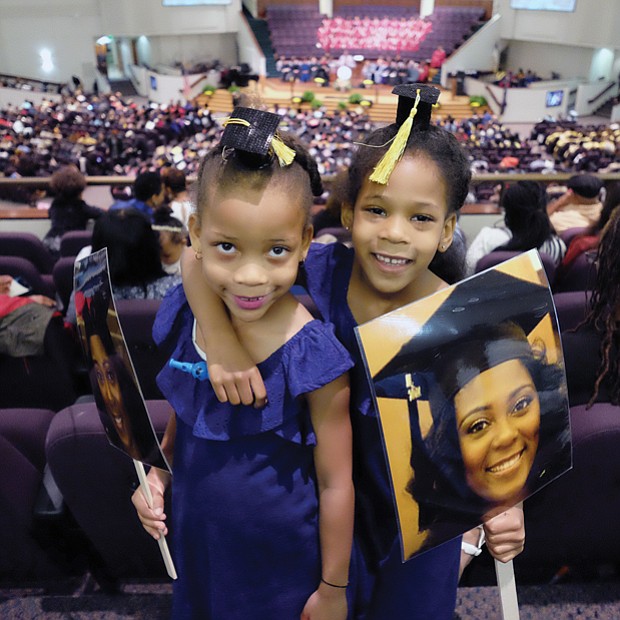 Future grads // Twins Cydney and Camryn Hamlin, 6, of Philadelphia are ready and waiting to see big sister Tyler Stafford get her degree at Virginia Union University’s commencement last Saturday at St. Paul’s Baptist Church. The duo led Ms. Stafford’s cheering section. Please see area commencement coverage and photos, B2 and B3.
