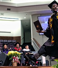 Marquis Johnson of Newport News is elated to get his degree in mass communications from Virginia Union University during Saturday’s ceremony at St. Paul’s Baptist Church in Henrico.