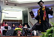 Marquis Johnson of Newport News is elated to get his degree in mass communications from Virginia Union University during Saturday’s ceremony at St. Paul’s Baptist Church in Henrico.