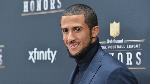 As Colin Kaepernick made his way to the podium, a surprised crowd broke into thunderous applause.