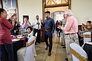Hometown basketball hero Frank Mason III signs the jersey of 7-year-old Davy Rasmussen during a celebration last Friday at Petersburg’s Union Station honoring the Petersburg native. The youngster was accompanied by his grandfather, Dick Gooley.