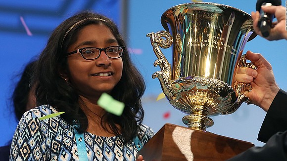 Ananya Vinay showed little emotion until she finally let a smile slip and lifted the Scripps National Spelling Bee trophy.