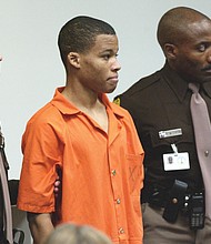 
Lee Boyd Malvo, 18, is surrounded by deputies as he is brought into Virginia Beach Circuit Court on Oct. 22, 2003.