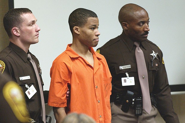 
Lee Boyd Malvo, 18, is surrounded by deputies as he is brought into Virginia Beach Circuit Court on Oct. 22, 2003.