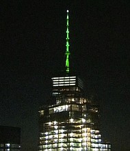 One World Trade Center lit up green in solidarity with Paris climate accord