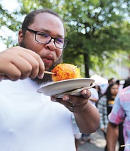 Bon appétit!
James Drake of Waverly puckers up after taking a bite of a mango on a stick dressed with lime juice, salt and chili. His buddy, Andrew Leisure of Richmond, laughs at Mr. Drake’s response to the dish prepared by Tio Pablo restaurant at the 10th Annual Broad Appétit in Downtown. About 30,000 people attended the event last Sunday that featured a range of foods, wines, beer and music along four blocks of Broad Street between Henry and Adams streets. The Downtown Neighborhood Association served as host, with proceeds benefiting FeedMore, the area’s nonprofit hunger relief organization. 