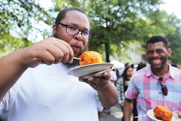 Bon appétit!
James Drake of Waverly puckers up after taking a bite of a mango on a stick dressed with lime juice, salt and chili. His buddy, Andrew Leisure of Richmond, laughs at Mr. Drake’s response to the dish prepared by Tio Pablo restaurant at the 10th Annual Broad Appétit in Downtown. About 30,000 people attended the event last Sunday that featured a range of foods, wines, beer and music along four blocks of Broad Street between Henry and Adams streets. The Downtown Neighborhood Association served as host, with proceeds benefiting FeedMore, the area’s nonprofit hunger relief organization. 