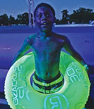 Fun in a different light //
When it comes to fun, a blacklight can enhance the event. George Boykin glows under the special lights set up at the Blacklight Slide, a water slide and dance party held last Saturday at Richmond International Raceway.