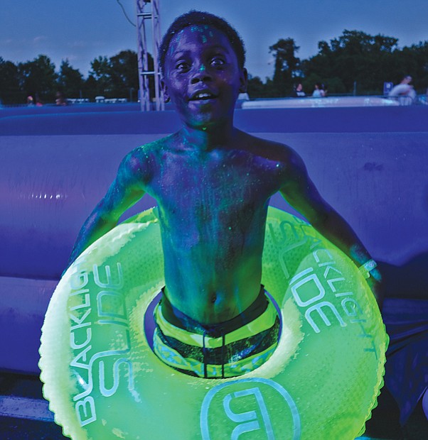 Fun in a different light //
When it comes to fun, a blacklight can enhance the event. George Boykin glows under the special lights set up at the Blacklight Slide, a water slide and dance party held last Saturday at Richmond International Raceway.