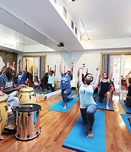 Yoga with a beat//
Ram Bhagat, left, and his drum circle set the beat for a yoga session last Friday at Saadia’s Juicebox and Yoga Bar on Second Street in Jackson Ward. The yoga studio was open as part of the monthly First Fridays festivities in Downtown. The session was led by Mr. Bhagat’s daughter, Kiran. 
