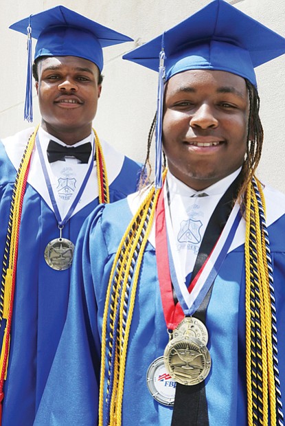 John Marshall High School valedictorian Tyreil Mayo, right, and salutatorian Gregory Jones, show their many medals and honor cords before their graduation Wednesday at the Altria Theater.