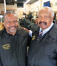 Clarence Oliver Jr. works side by side with his dad, Clarence Oliver Sr., at Supreme Hairstyling Lounge in Jackson Ward. The shop has been at its 1st Street location since 1976.